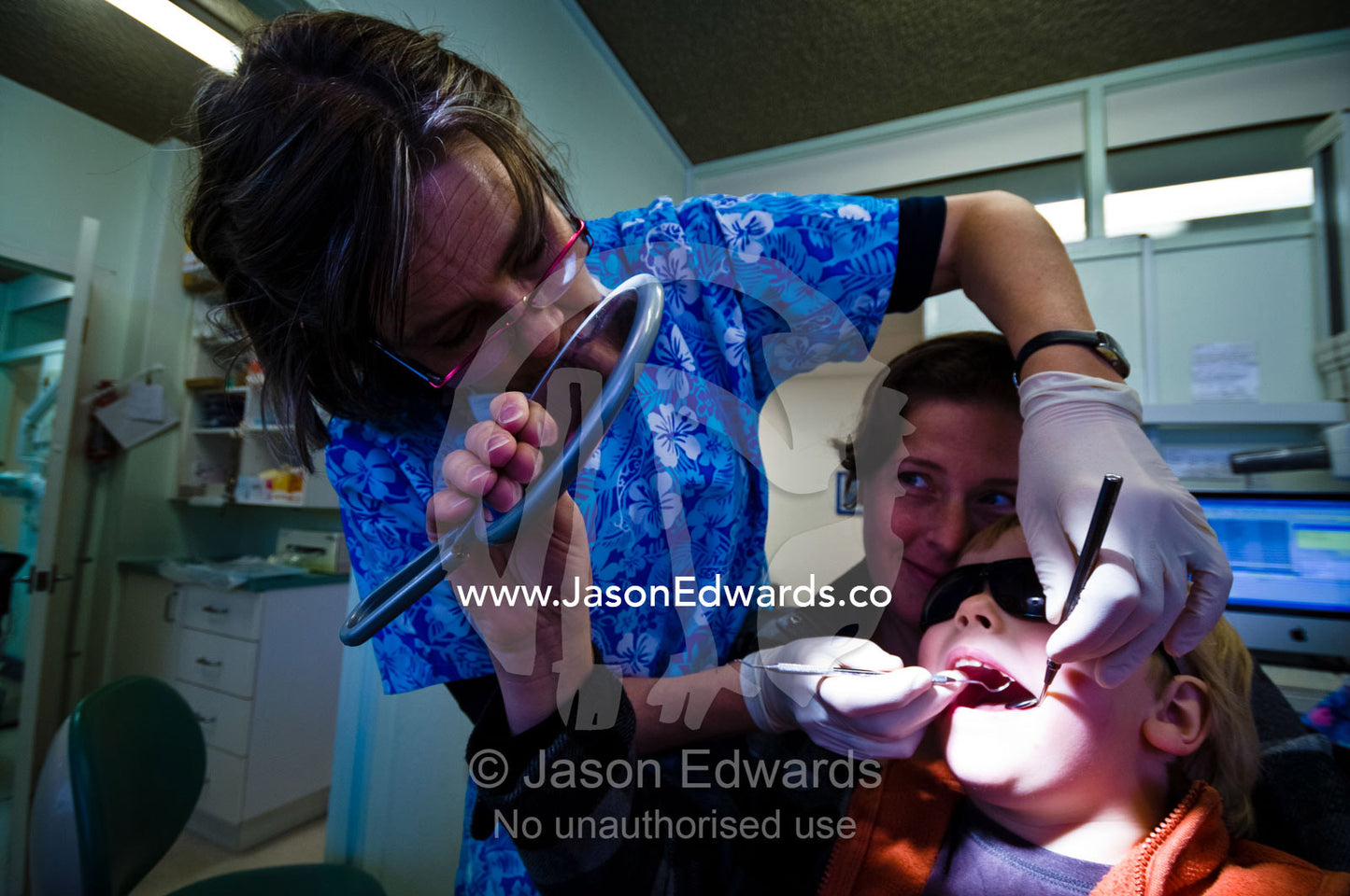 A dentist examines a small boy's baby teeth during his first check-up. East Melbourne, Melbourne, Victoria, Australia.