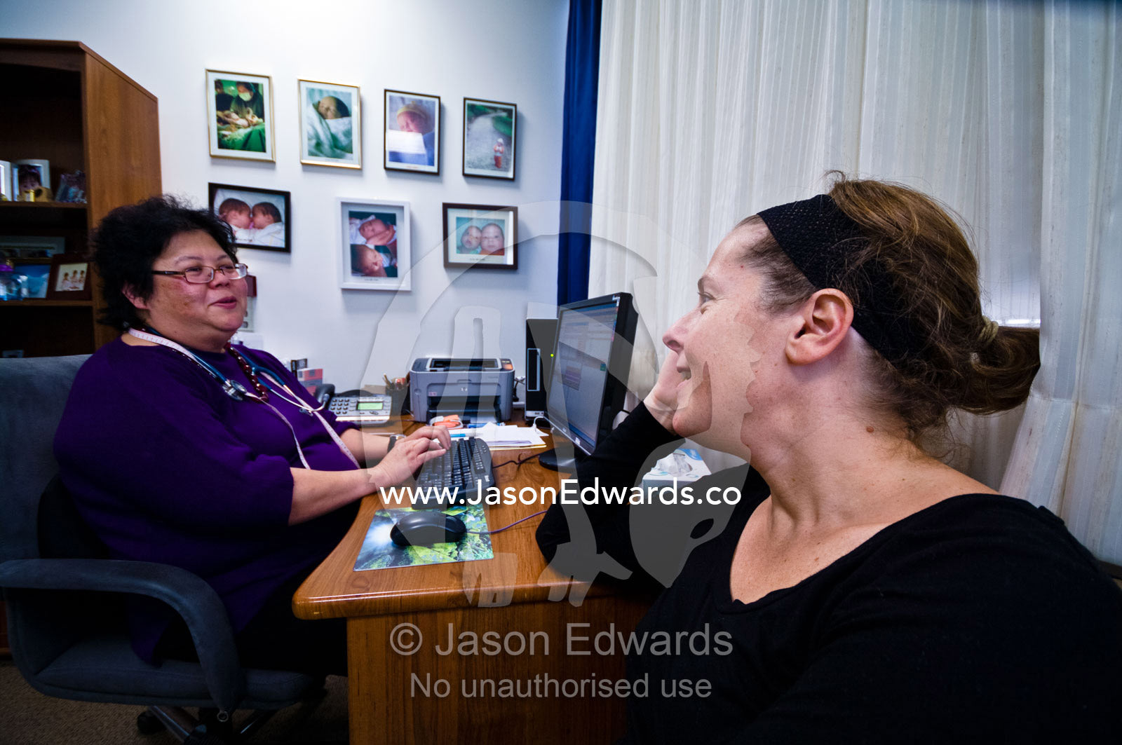 A woman meets with her obstetrician to discuss pregnancy options. Royal Women's Hospital, Carlton, Melbourne, Victoria, Australia.
