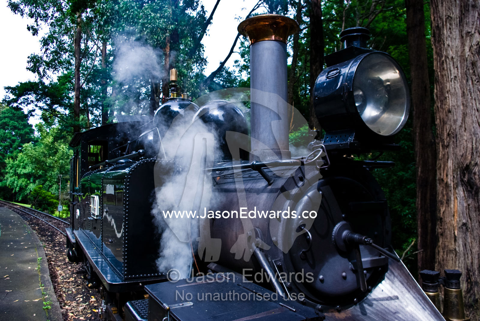 Steam funnels out a pressure release valve on an antique steam engine. Lakeside, Emerald, Melbourne, Victoria, Australia.