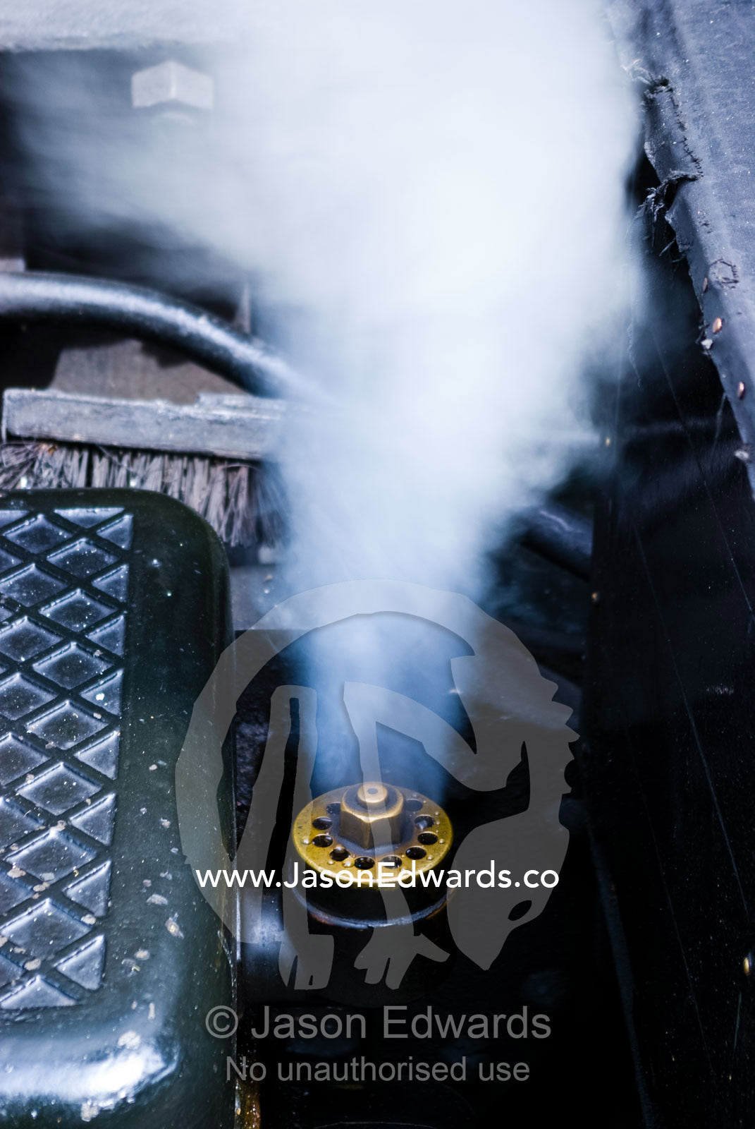 Steam funnels out a pressure release valve on an antique steam engine. Lakeside, Emerald, Melbourne, Victoria, Australia.