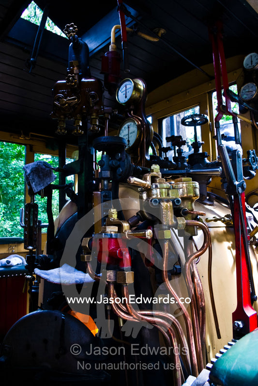 The boiler room and calliper breaks on a restored antique steam train. Lakeside, Emerald, Melbourne, Victoria, Australia.