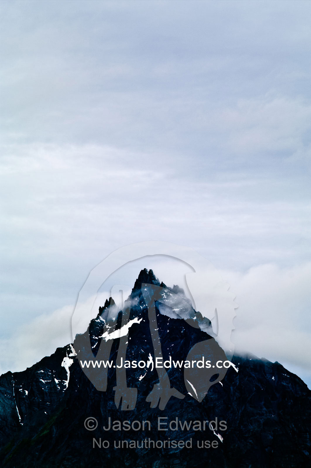 Storm clouds gather around the jagged summit of an Andes mountain. Mount Olivia, Martial Mountains, Fuegian Andes, Ushuaia Bay, The Beagle Channel, Tierra del Fuego Archipelago, Straits of Magellan, Ushuaia, Tierra del Fuego Province, Patagonia, Argentina.