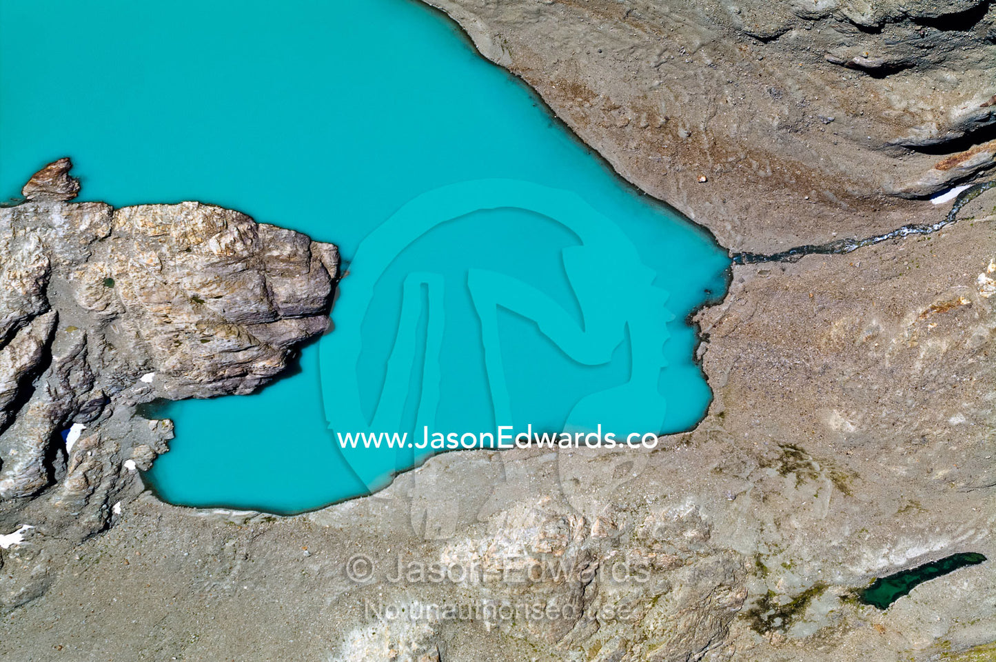 A lake fills with mineral-rich turquoise water from a glacier run-off. Ushuaia, Martial Mountains, Fuegian Andes, Ushuaia Bay, Tierra del Fuego Archipelago, Straits of Magellan, Tierra del Fuego Province, Patagonia, Argentina.
