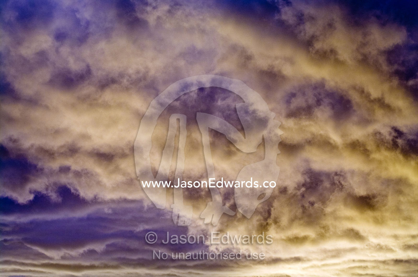 A quilt of purple and orange clouds descends over the ocean at sunset. Ushuaia, Martial Mountains, Fuegian Andes, Ushuaia Bay, The Beagle Channel, Tierra del Fuego Archipelago, Straits of Magellan, Tierra del Fuego Province, Patagonia, Argentina.