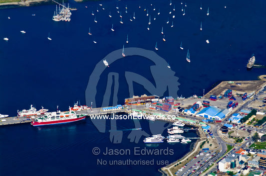 Container ships, yachts and tourist ships in a sheltered city harbor. Ushuaia Bay, The Beagle Channel, Tierra del Fuego Archipelago, Straits of Magellan, Ushuaia, Tierra del Fuego Province, Patagonia, Argentina.