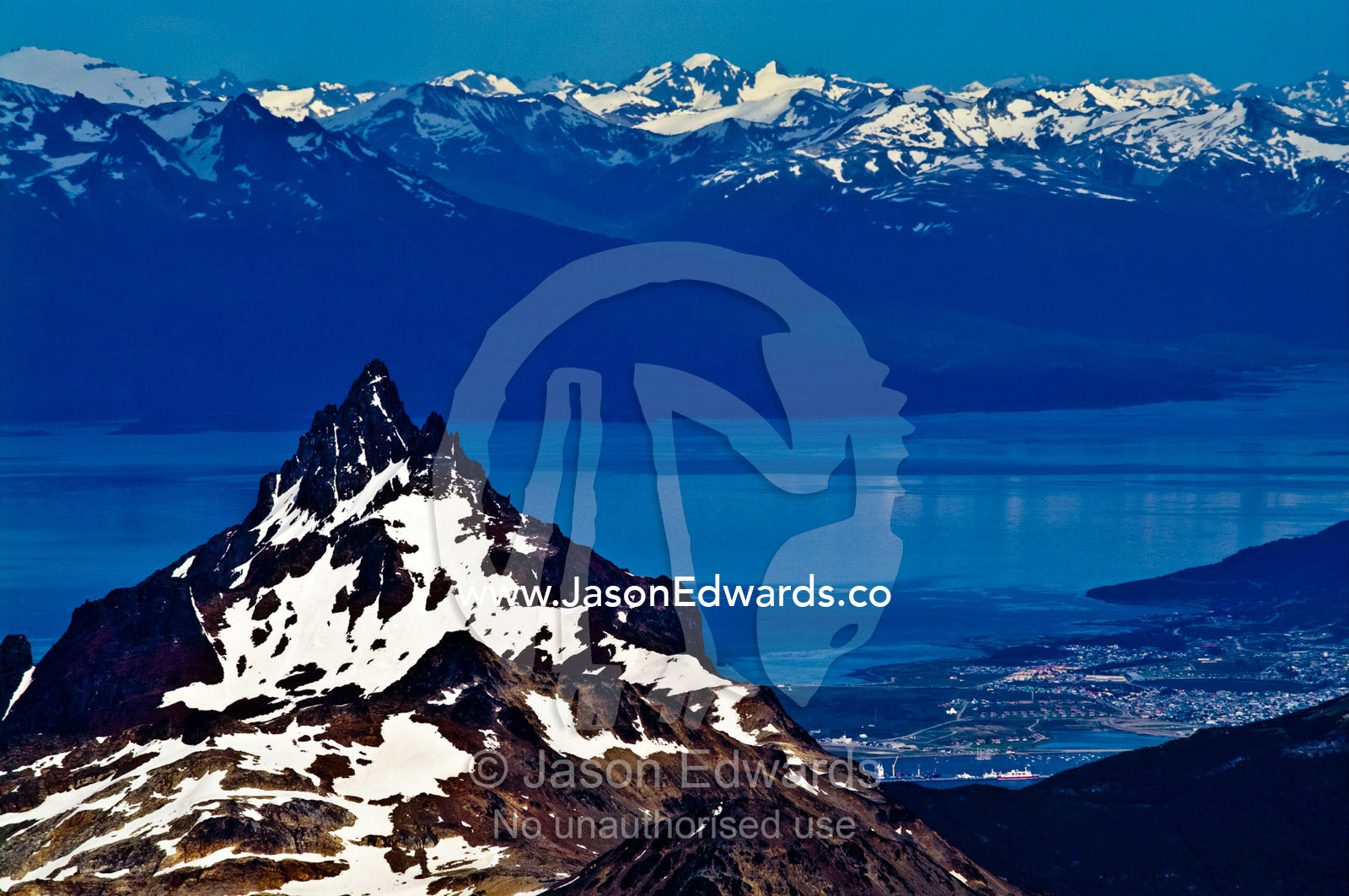 The snow covered peak of Mount Olivia overlooking the Chilean Andes. Ushuaia, Beagle Channel, Martial Mountains, Fuegian Andes, Ushuaia Bay, Tierra del Fuego Archipelago, Straits of Magellan, Tierra del Fuego Province, Patagonia, Argentina.