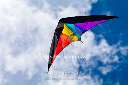 A delta-winged kite flashing primary colours in the summer sky. Venus Bay, Cape Liptrap Coastal Park, Bass Strait, South Gippsland, Victoria, Australia.