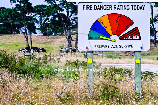 The arrow on a bushfire warning sign indicates the level of threat. Venus Bay, South Gippsland, Victoria, Australia.
