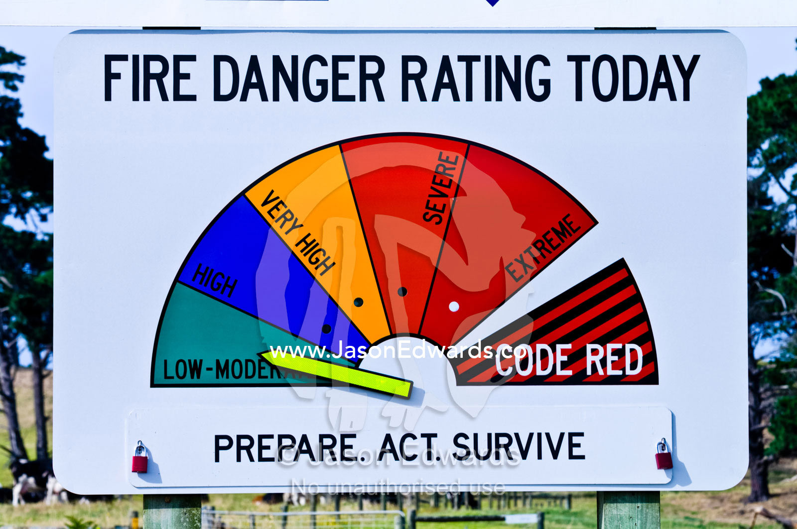 The arrow on a bushfire warning sign indicates the level of threat. Venus Bay, South Gippsland, Victoria, Australia.