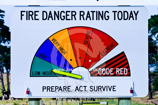The arrow on a bushfire warning sign indicates the level of threat. Venus Bay, South Gippsland, Victoria, Australia.
