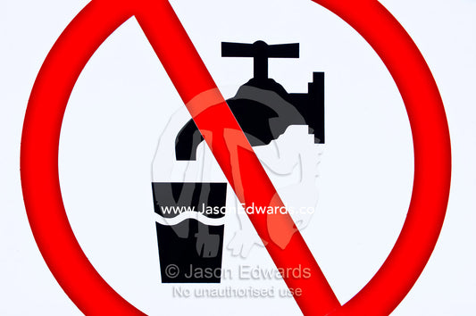 A red warning sign indicates the danger in drinking bore water. Venus Bay, South Gippsland, Victoria, Australia.