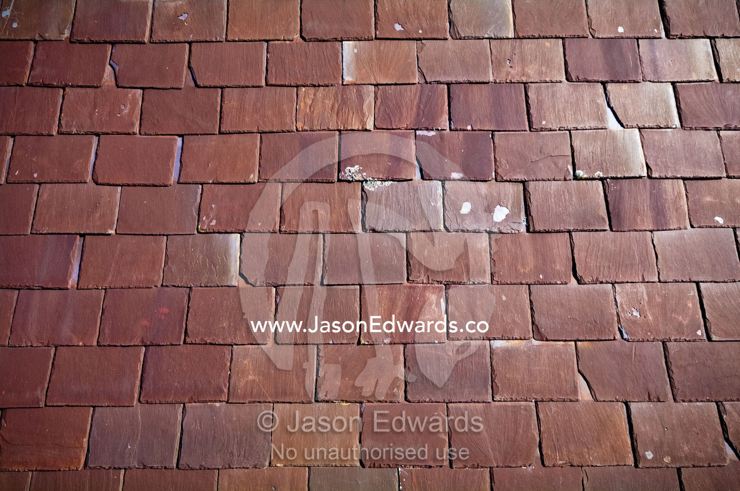 Rows of heritage layered slate tiles on a Victorian terrace roof. Carlton North, Melbourne, Victoria, Australia.