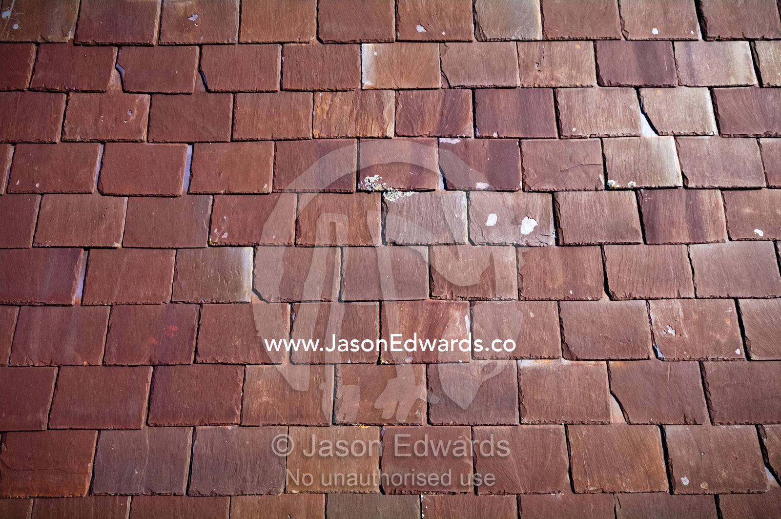 Rows of heritage layered slate tiles on a Victorian terrace roof. Carlton North, Melbourne, Victoria, Australia.