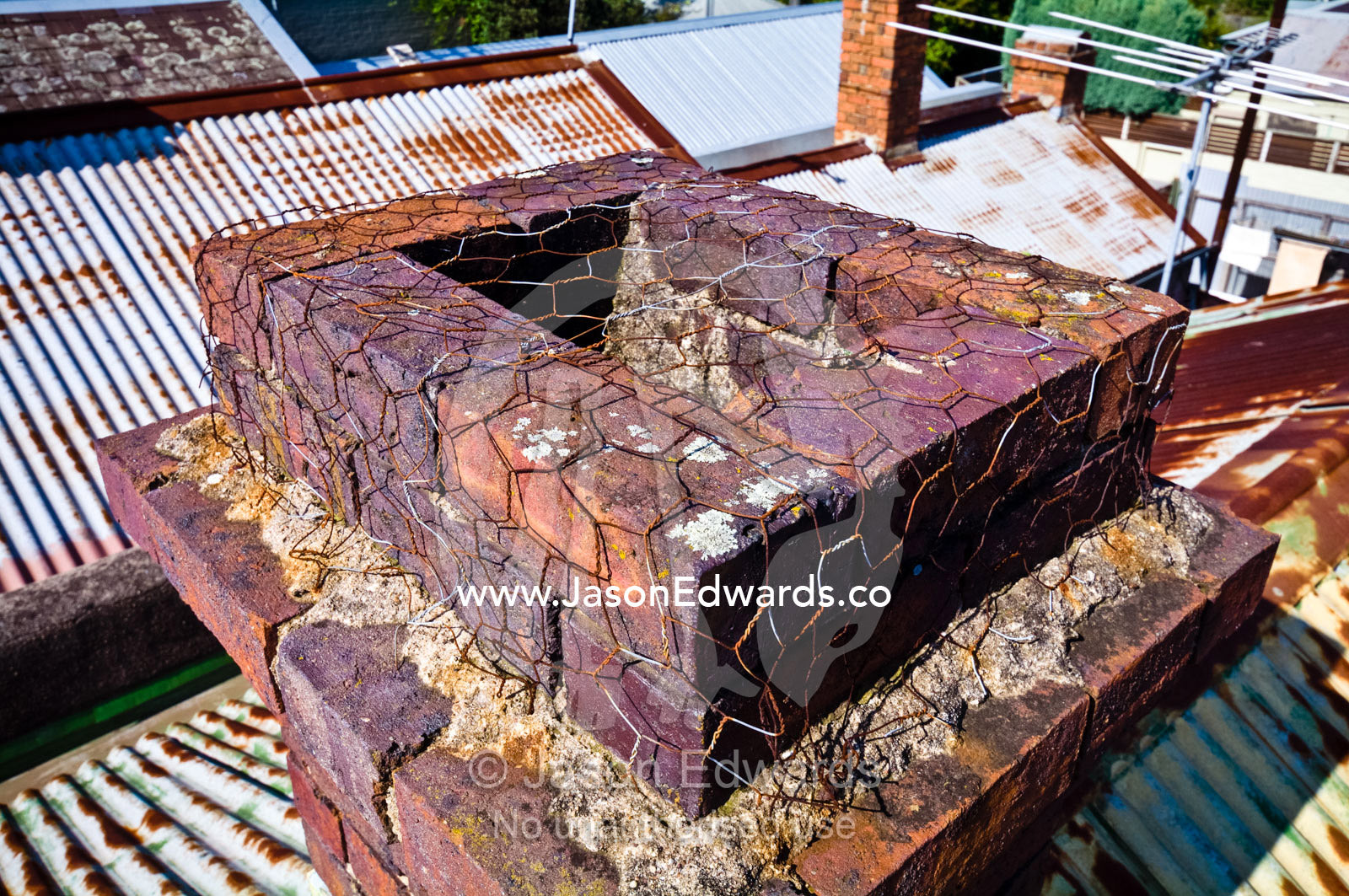 Chicken wire on a chimney stops opossums from entering a house roof. Carlton North, Melbourne, Victoria, Australia.