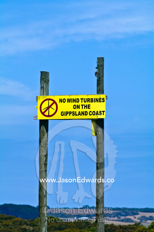 Protest sign banning wind turbines in a coastal farming community. Walkerville, Cape Liptrap Coastal Park, Bass Strait, South Gippsland, Victoria, Australia.