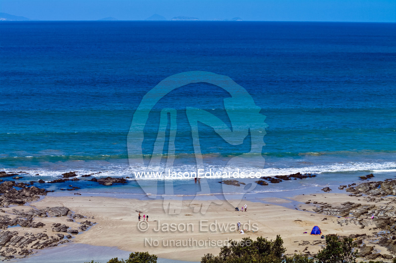Families play on a remote sheltered beach by a turquoise ocean. Walkerville, Cape Liptrap Coastal Park, Bass Strait, South Gippsland, Victoria, Australia.