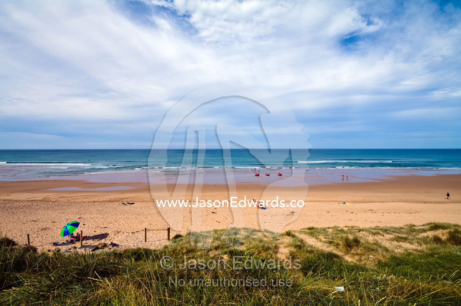 A lone beach umbrella on a wide beach in summer. Venus Bay, Cape Liptrap Coastal Park, Bass Strait, South Gippsland, Victoria, Australia.