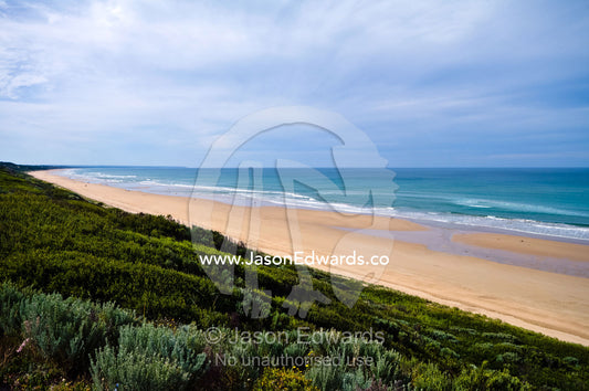 A vast sandy beach fronts Tea Tree scrub on coastal sand dunes. Venus Bay, Cape Liptrap Coastal Park, Bass Strait, South Gippsland, Victoria, Australia.