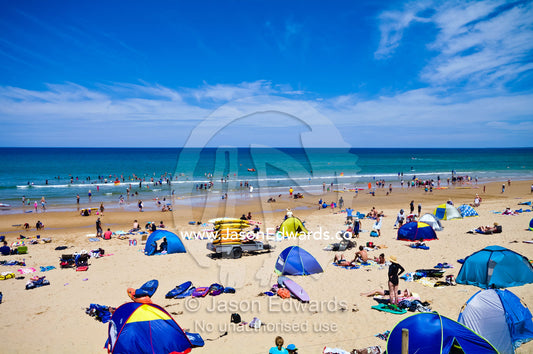 Beach domes, surfboards and families on a crowded beach in summer. Venus Bay, Cape Liptrap Coastal Park, Bass Strait, South Gippsland, Victoria, Australia.
