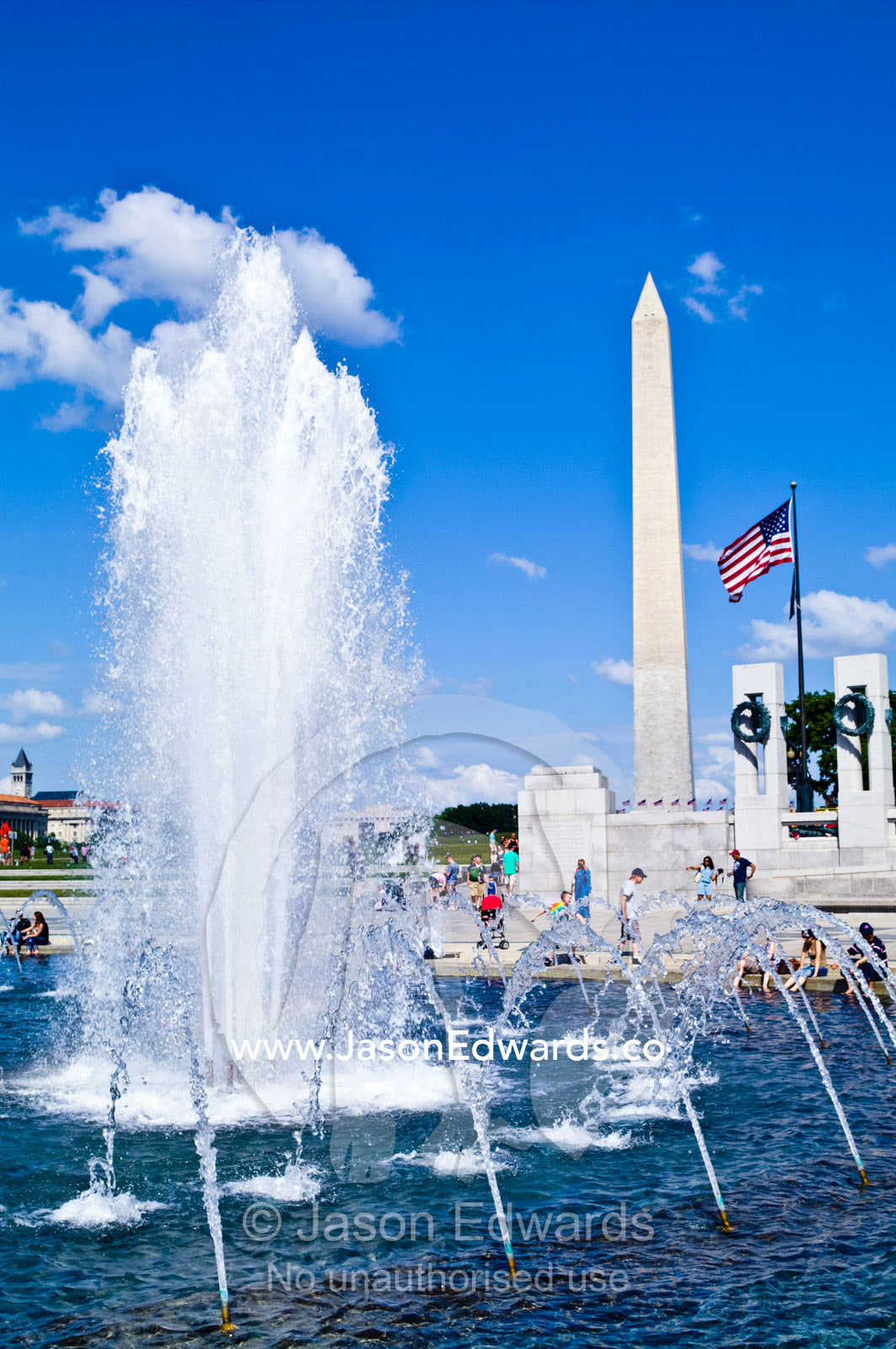Fountains fill the Rainbow Pool on a bright, sunny Memorial Day. The Memorial Plaza, World War II Memorial, National Mall, District of Columbia, United States of America.