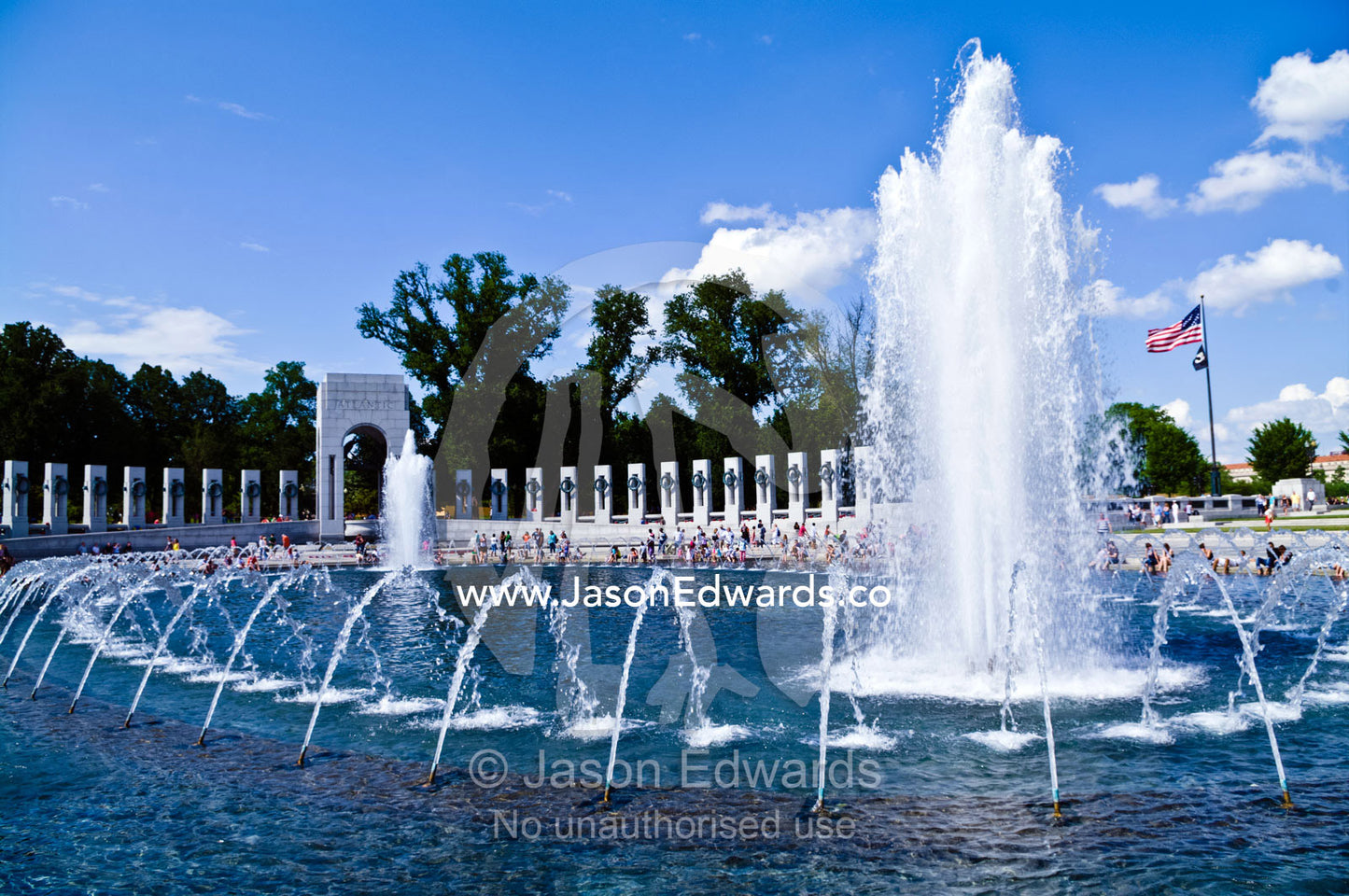Fountains fill the Rainbow Pool on a bright, sunny Memorial Day. The Memorial Plaza, World War II Memorial, National Mall, Washington, District of Columbia, United States of America.