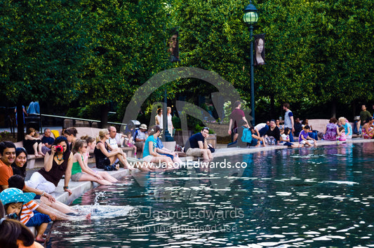 Tourists cool their feet in the fountain pool on Memorial Day. National Gallery of Art, National Mall, Washington, District of Columbia, United States of America.