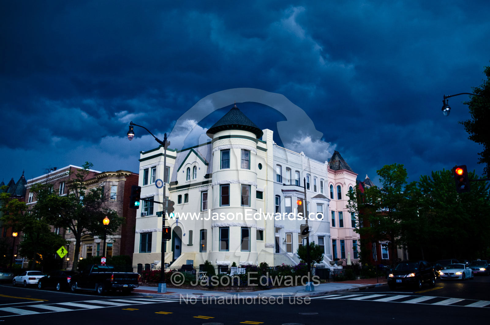 A dark menacing summer storm over apartments at an intersection. Dupont Circle, Washington, District of Columbia, United States of America.