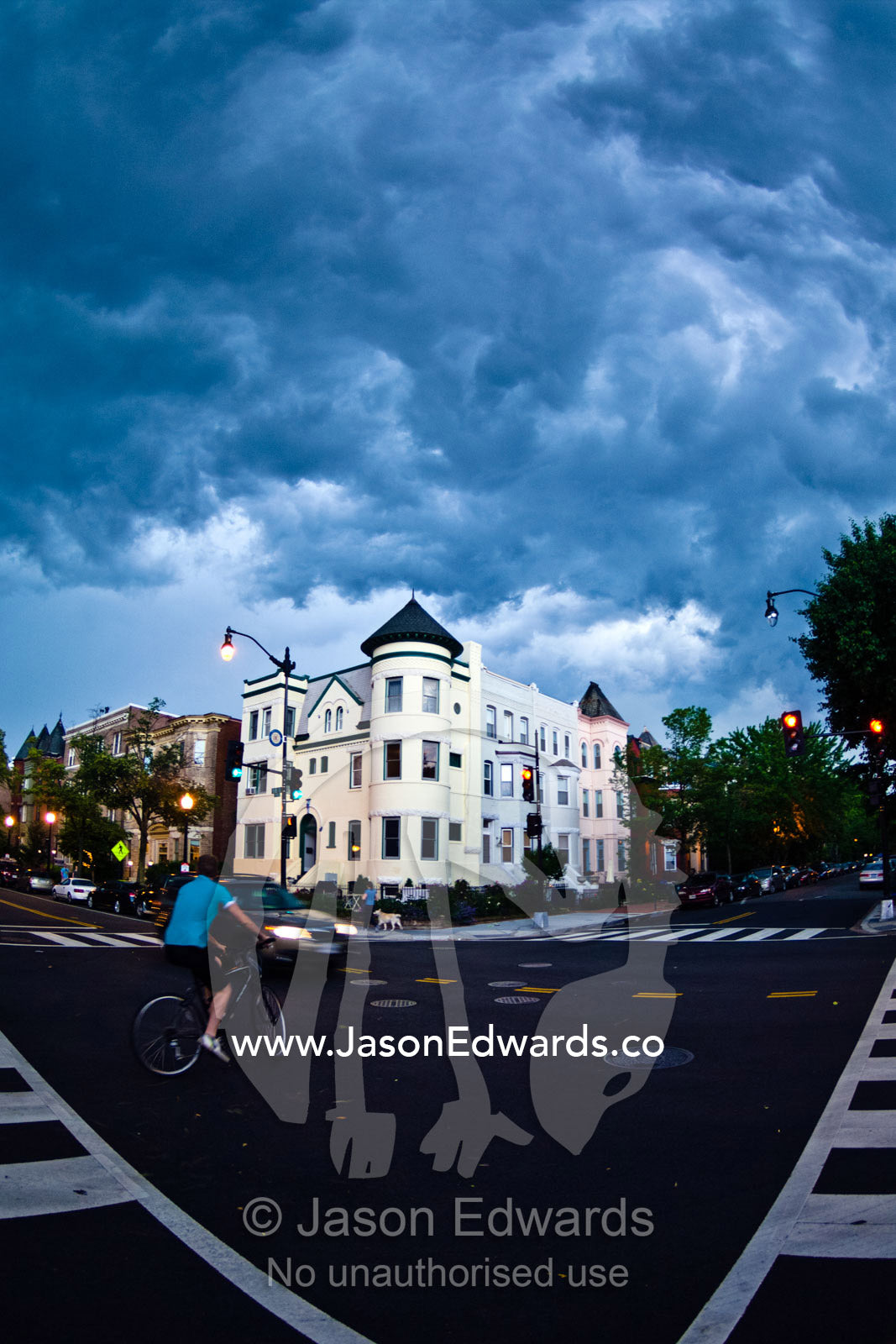 A dark menacing summer storm over apartments at an intersection. Dupont Circle, Washington, District of Columbia, United States of America.