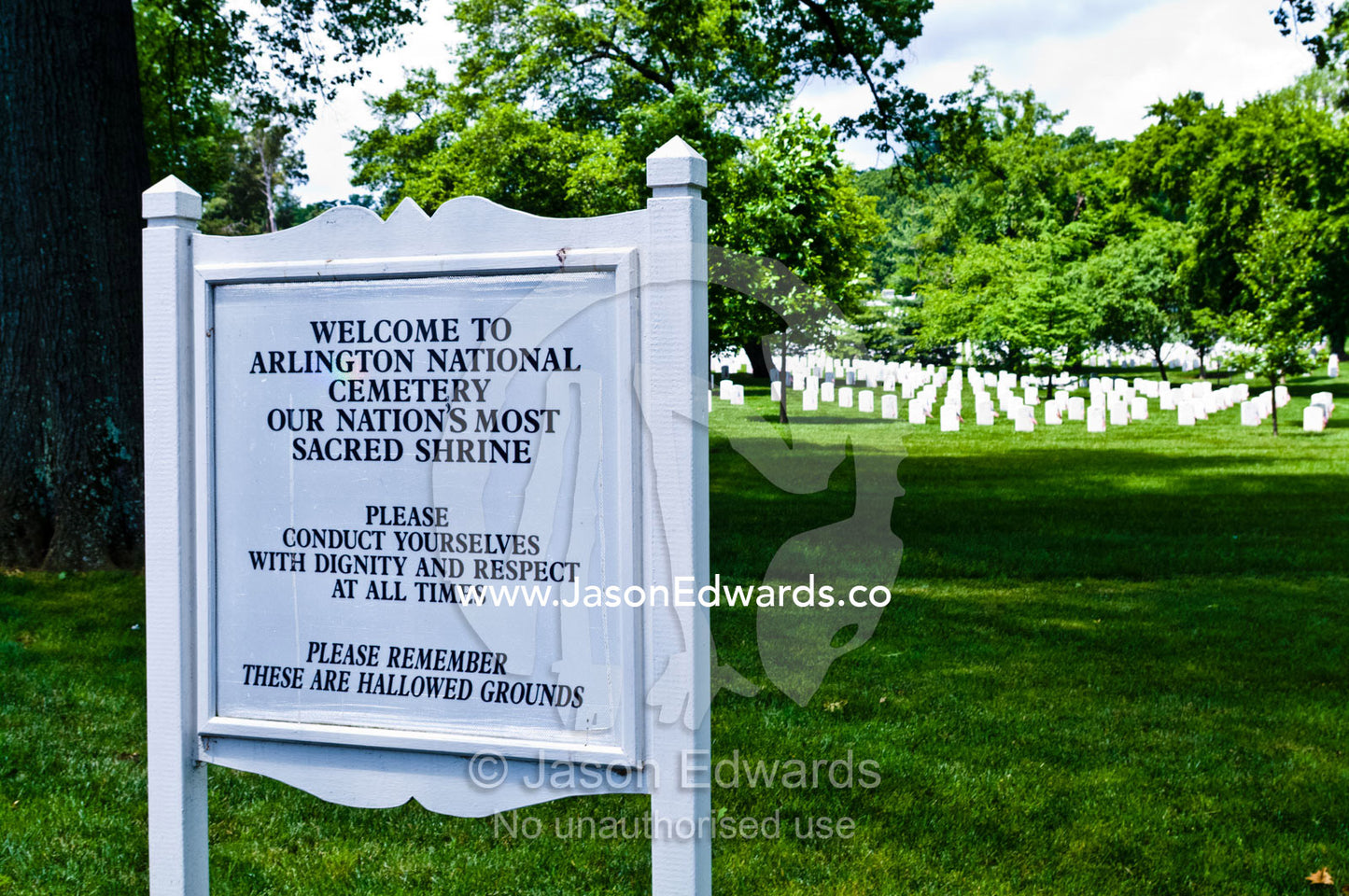 A cemetery sign welcomes visitors to a cemetery and requests respect. Arlington National Cemetery, Arlington, Virginia, United States of America.