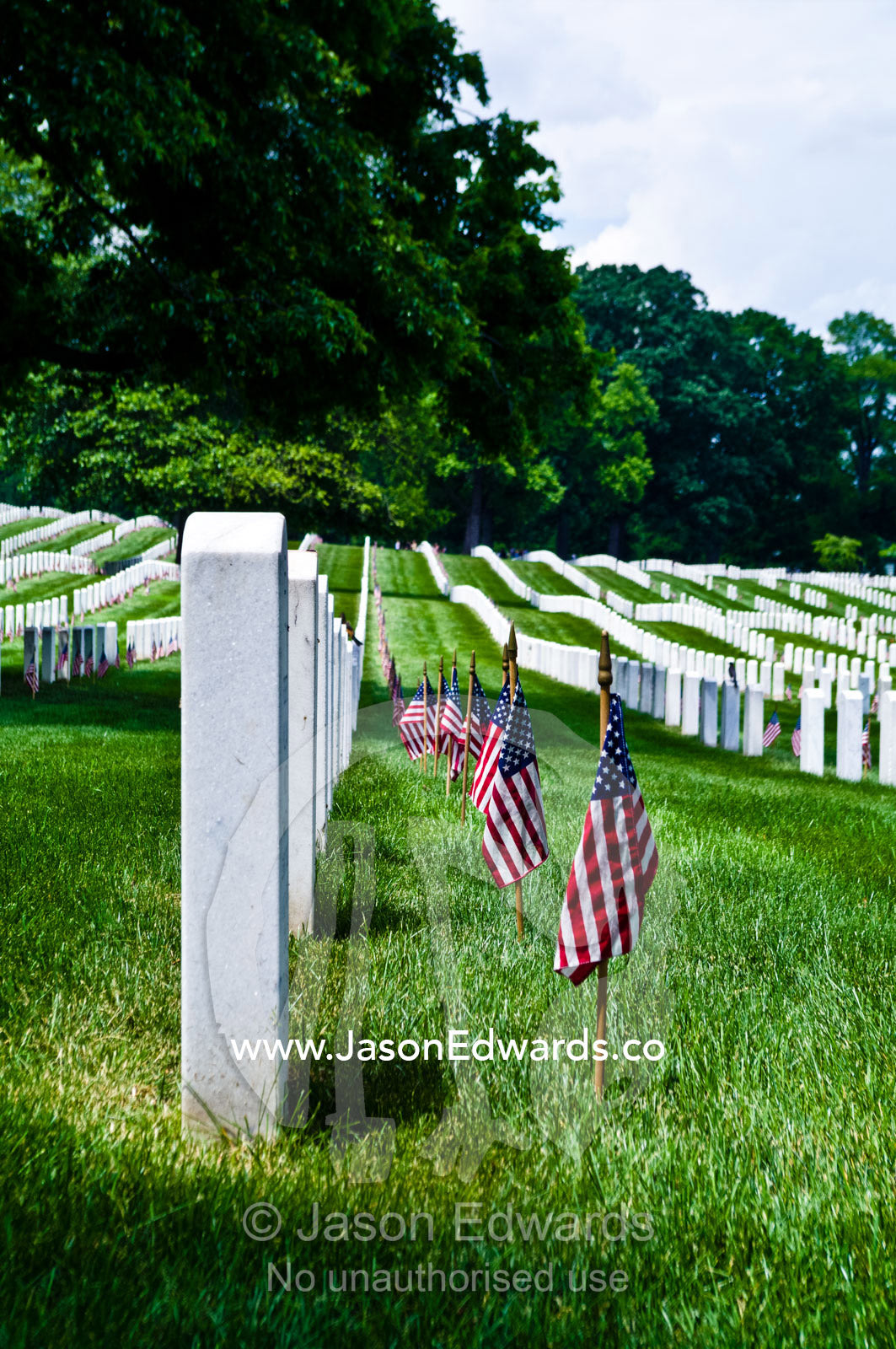 On Memorial Day American flags adorn cemetery tombstones and graves. Arlington National Cemetery, Arlington, Virginia, United States of America.