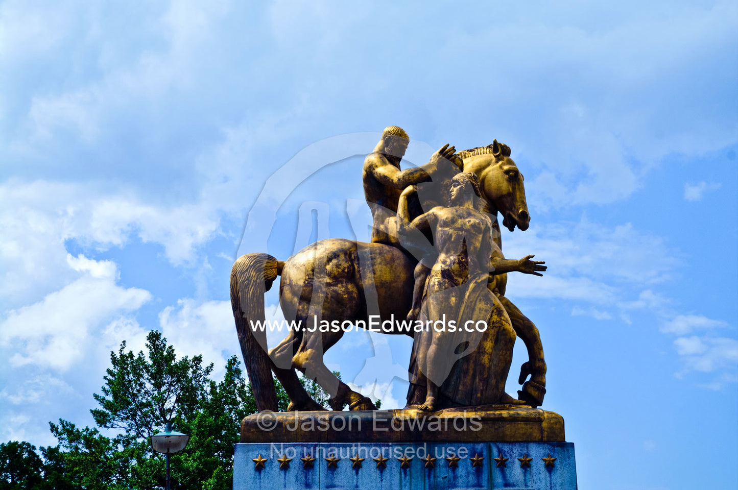 A gilded bronze statue by the Potomac River featuring Mars on a horse. Arlington Bridge Equestrian Statues, Arlington Memorial Bridge, Lincoln Memorial, National Mall, Washington, District of Columbia, United States of America.