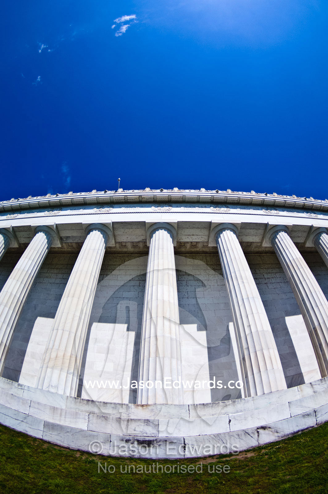 Lincoln Memorial marble Greek Doric columns rise into a blue sky. Lincoln Memorial, National Mall, Washington, District of Columbia, United States of America.