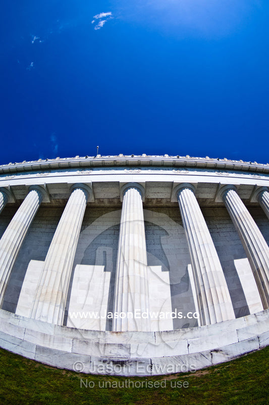 Lincoln Memorial marble Greek Doric columns rise into a blue sky. Lincoln Memorial, National Mall, Washington, District of Columbia, United States of America.
