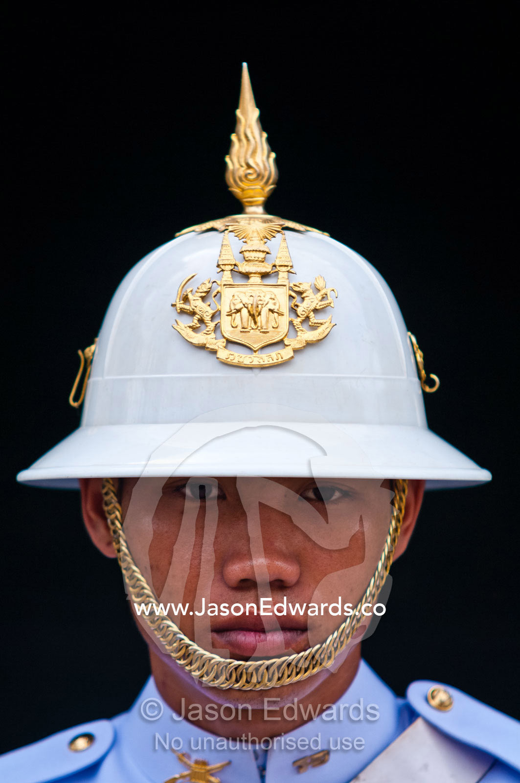 A soldier of the Kings Guard with a white helmet and gold chin-strap. Chakri Maha Prasad, The Grand Palace, The Lord's Supreme Palace, Royal Palace, Bangkok, Thailand.