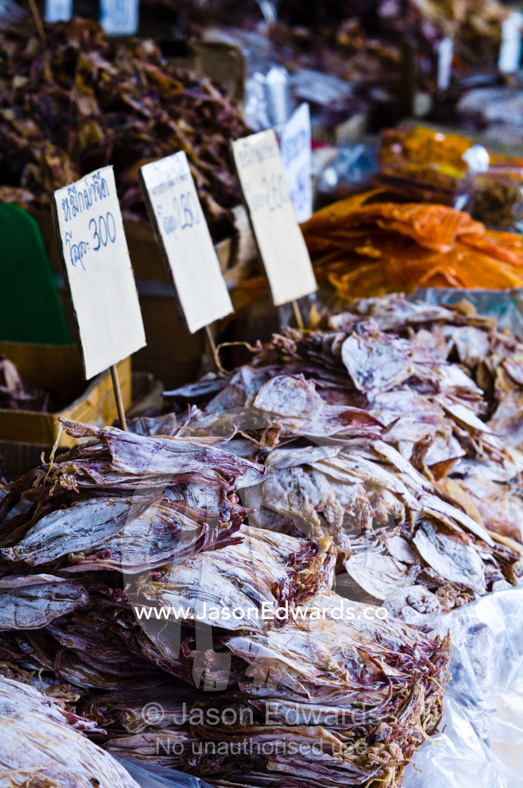 Piles of dried squid and seafood for sale in an open air market. Phra Nakhon District, Rattanakosin District, Bangkok, Thailand.