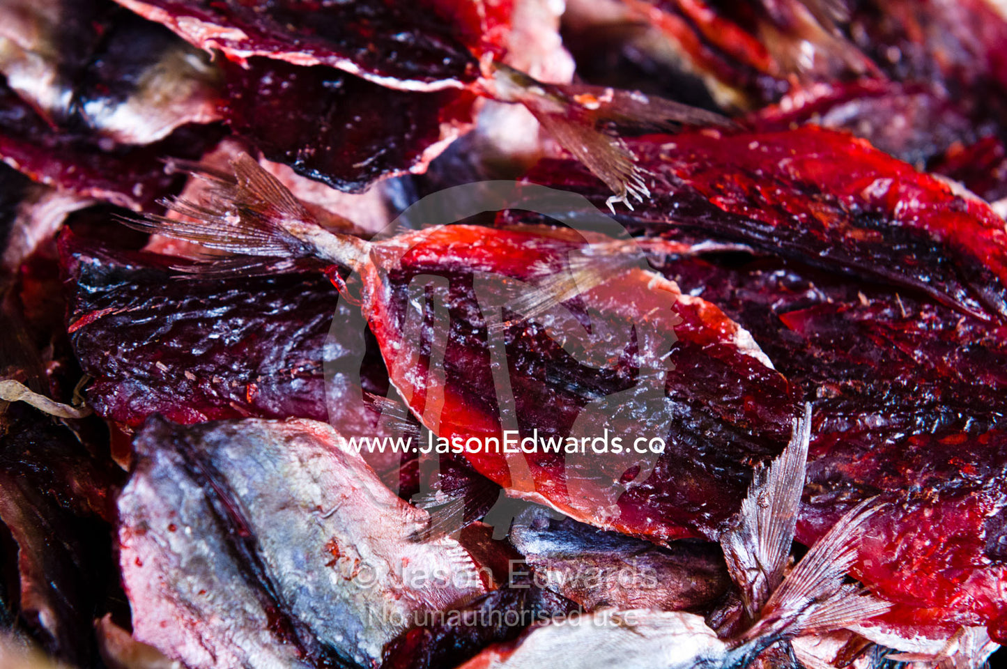 Dried bright red filleted fish for sale in an open air market stall. Phra Nakhon District, Rattanakosin District, Bangkok, Thailand.