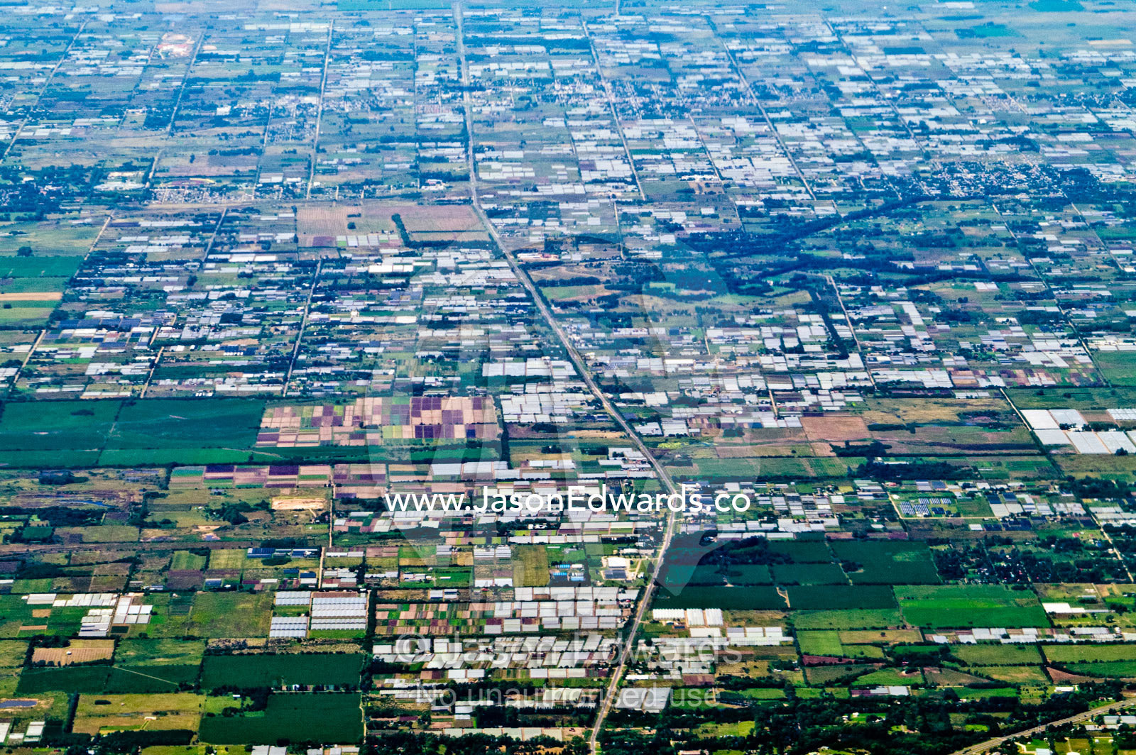A patchwork of farmland paddocks, factories and warehouses on a plain. south of Buenos Aires, Southern Argentina.