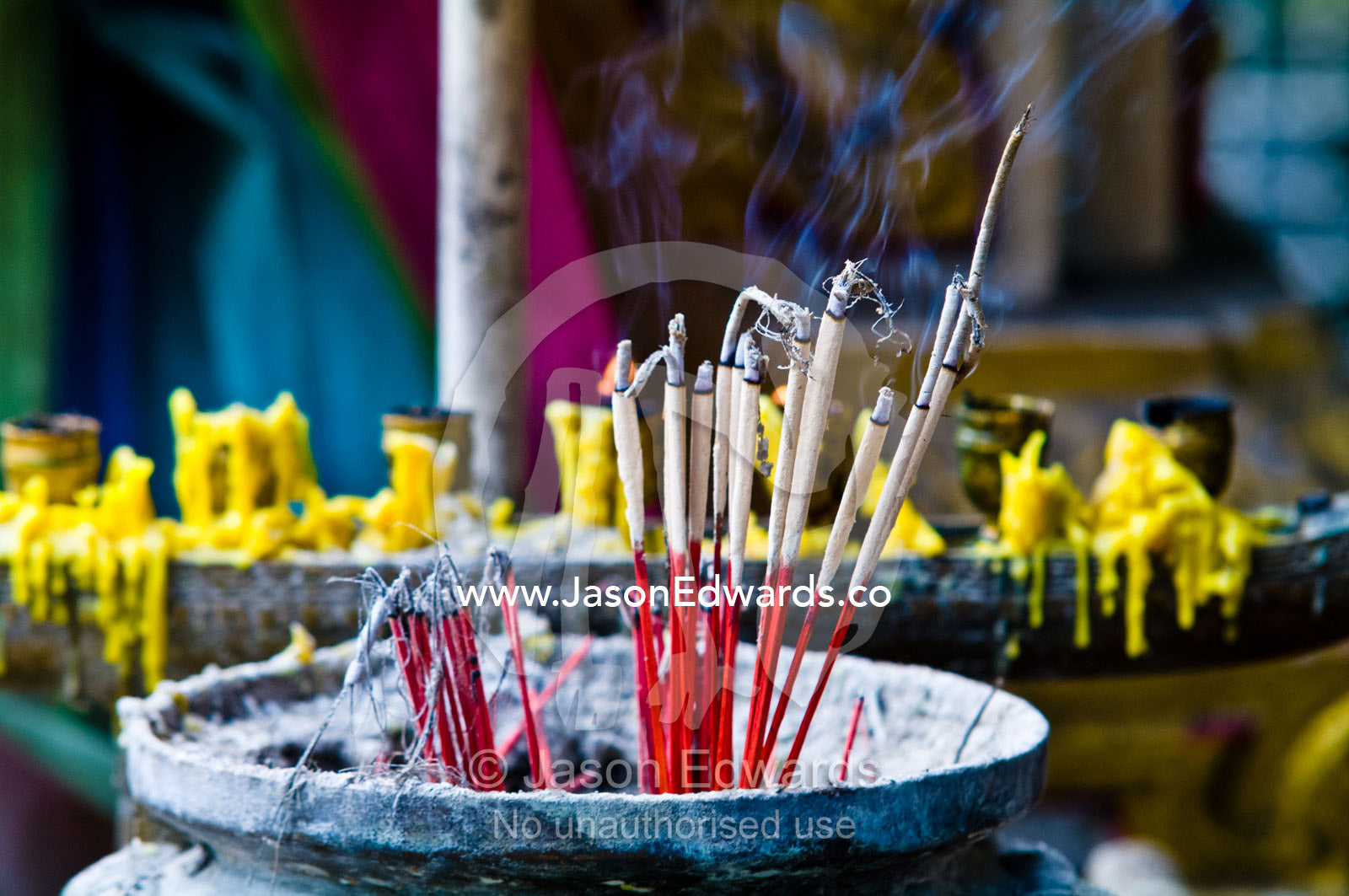 Incense and candles burning in a small temple in a riverside market. Wat Suwan Cross Ferry Pier, near the Grand Palace, The Lord's Supreme, Great Royal Palace, Chao Phraya River, Bangkok, Thailand.
