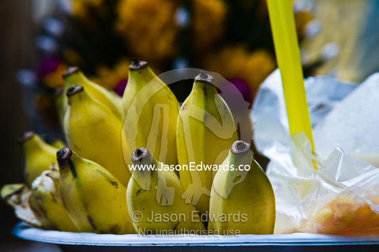 Bananas for sale as prayer offerings in a small riverside market. Wat Suwan Cross Ferry Pier, near the Grand Palace, The Lord's Supreme, Great Royal Palace, Chao Phraya River, Bangkok, Thailand.