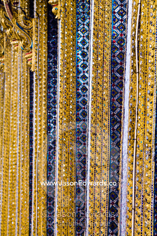 Glass tile mosaic and gold leaf decorate ornate pillars of a temple. Prasat Phra Thep Bidon, Royal Pantheon, Wat Phra Kaew, Wat Phra Kaeo, Temple of the Emerald Buddha, Bangkok, Thailand.