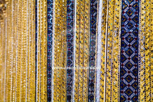 Glass tile mosaic and gold leaf decorate ornate pillars of a temple. Prasat Phra Thep Bidon, Royal Pantheon, Wat Phra Kaew, Wat Phra Kaeo, Temple of the Emerald Buddha, Bangkok, Thailand.