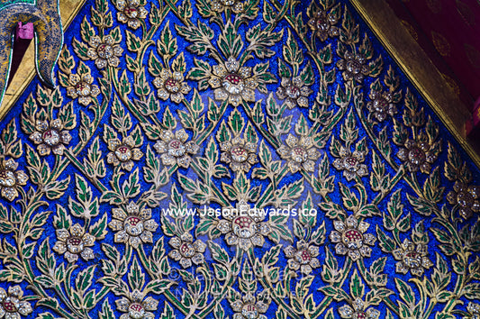 Intricate patterns of leaves and flowers on the facade of a temple. Wat Pho, Temple of the Reclining Buddha, Wat Chetuphon, Phra Nakhon District, Rattanakosin District, Bangkok, Thailand.