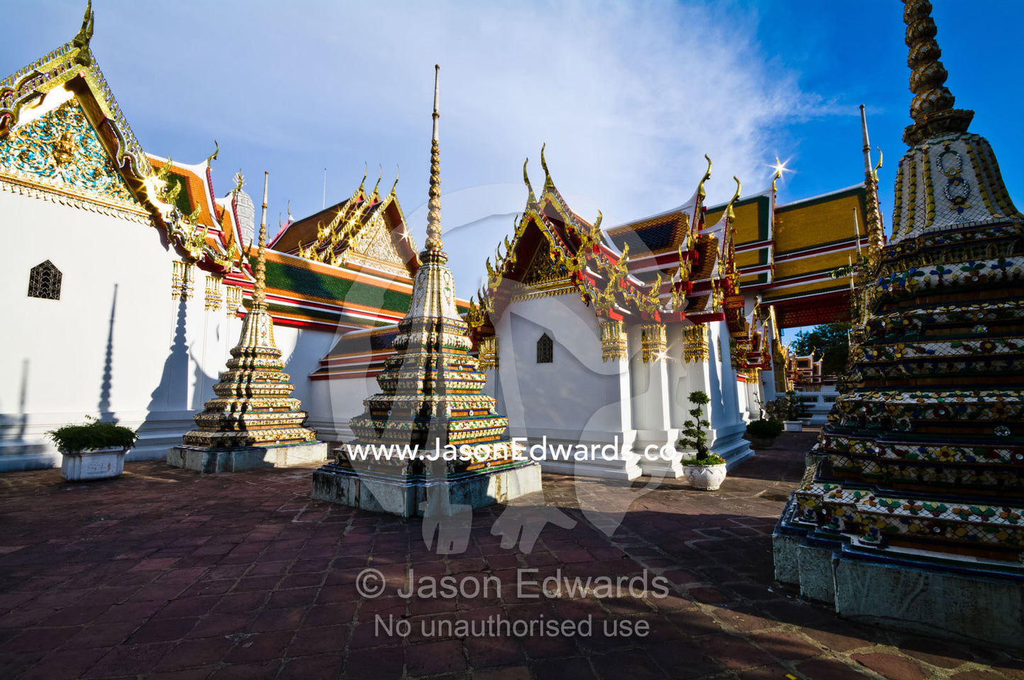 A collection of ornate prangs in a Buddhist temple courtyard. Wat Pho, Temple of the Reclining Buddha, Wat Chetuphon, Phra Nakhon District, Rattanakosin District, Bangkok, Thailand.