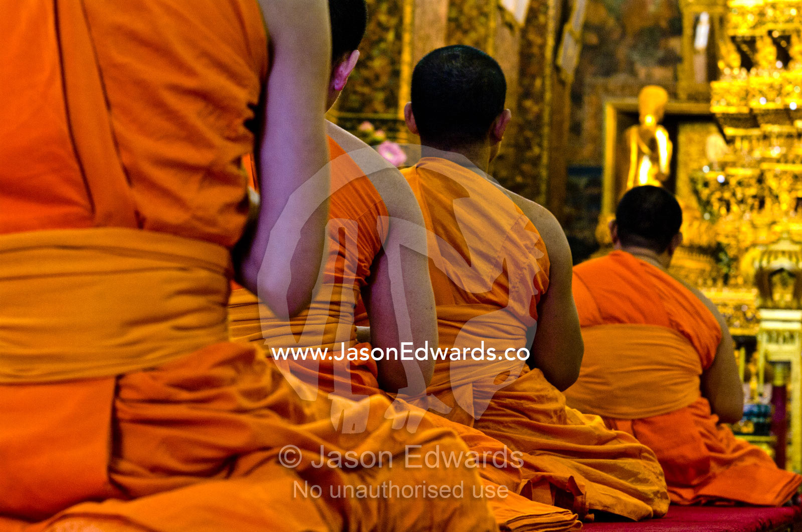 Buddhist monks in deep prayer in the Ubosot, the temple's chapel. Wat Pho, Temple of the Reclining Buddha, Wat Chetuphon, Phra Nakhon District, Rattanakosin District, Bangkok, Thailand.