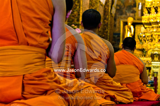 Buddhist monks in deep prayer in the Ubosot, the temple's chapel. Wat Pho, Temple of the Reclining Buddha, Wat Chetuphon, Phra Nakhon District, Rattanakosin District, Bangkok, Thailand.