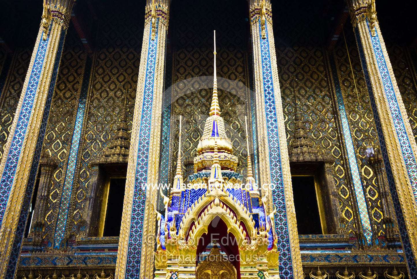 A shrine with golden prangs near the Temple of the Emerald Buddha. Wat Phra Kaew, Wat Phra Kaeo, Temple of the Emerald Buddha, Bangkok, Thailand.