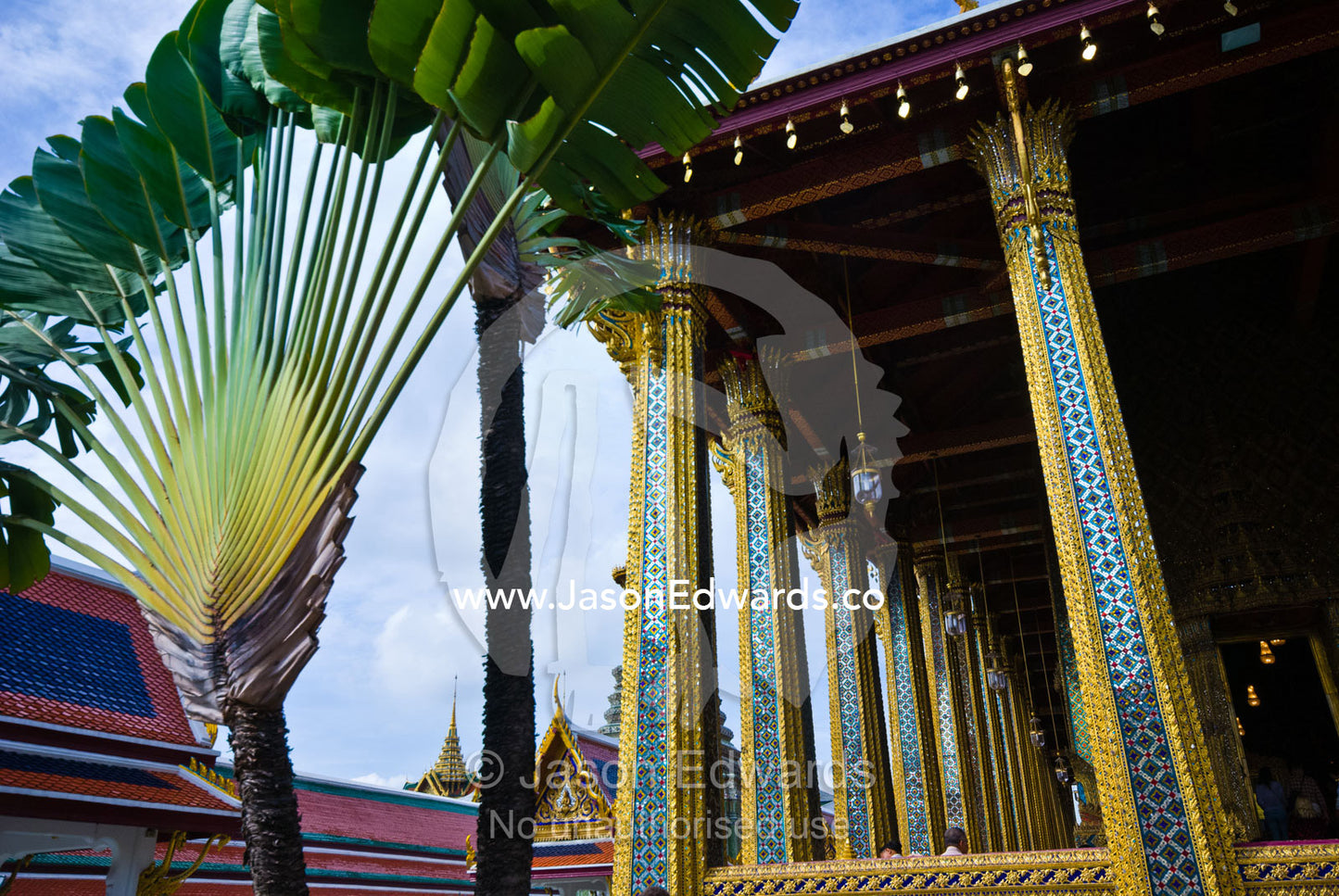 Palm fronds near gilded pillars at the Temple of the Emerald Buddha. Wat Phra Kaew, Wat Phra Kaeo, Temple of the Emerald Buddha, Bangkok, Thailand.