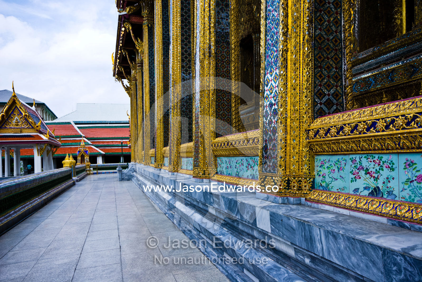 Glass tile mosaic and gold leaf decorate temple pillars and walls. Wat Phra Kaew, Wat Phra Kaeo, Temple of the Emerald Buddha, Bangkok, Thailand.