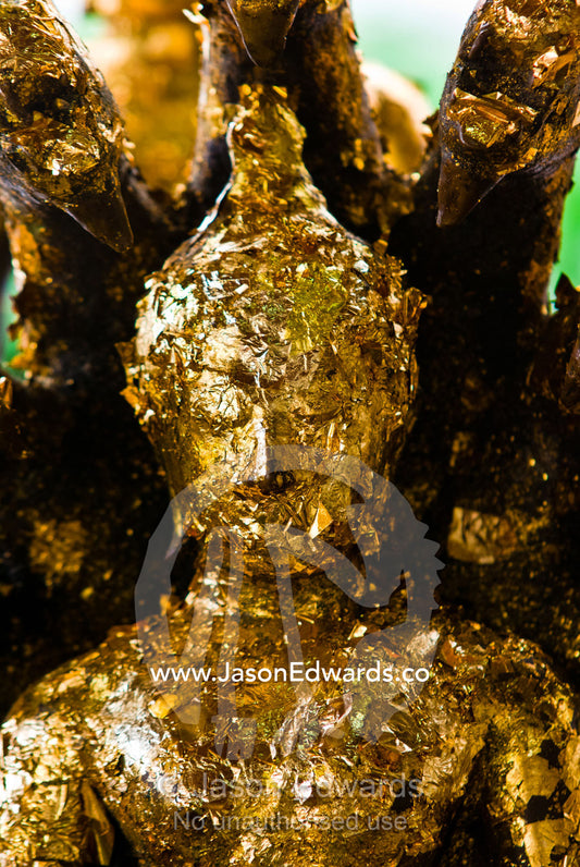 Worshippers stick gold flakes to statues of Buddha and offer prayers. Wat Pho, Temple of the Reclining Buddha, Wat Chetuphon, Phra Nakhon District, Rattanakosin District, Bangkok, Thailand.