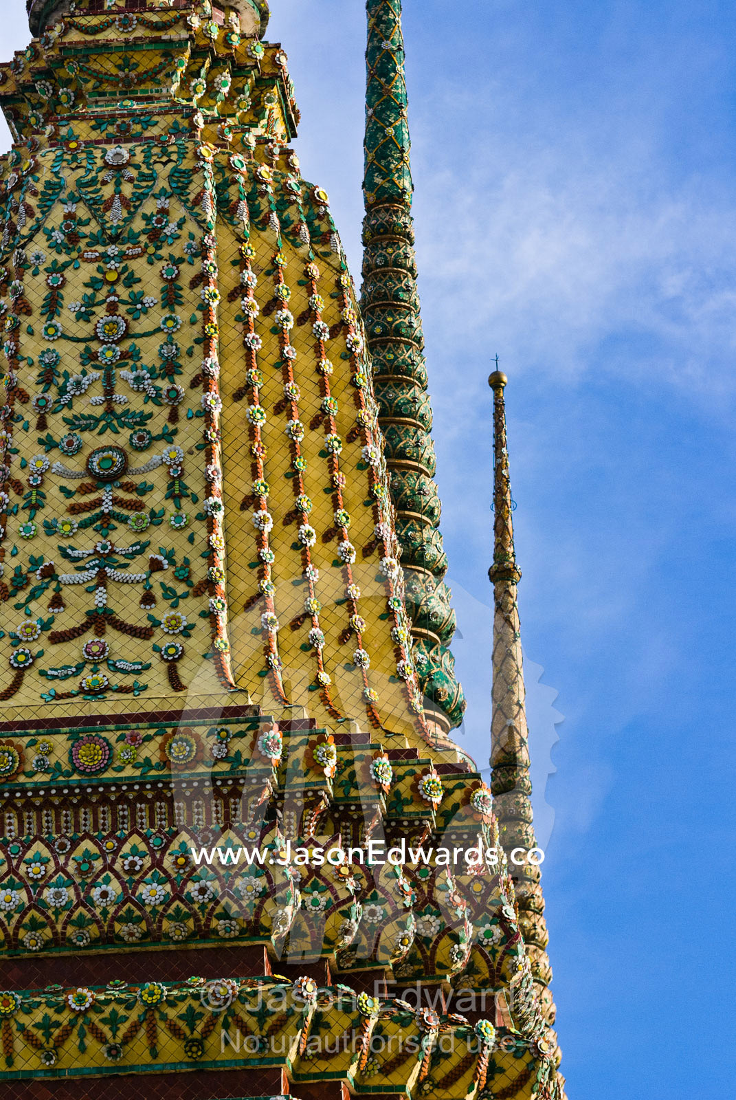 An ornately carved and decorated spire known as a prang atop a temple. Wat Pho, Temple of the Reclining Buddha, Wat Chetuphon, Phra Nakhon District, Rattanakosin District, Bangkok, Thailand.